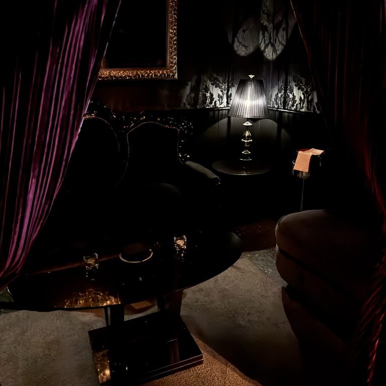 Velvet curtains and a lamp-lit private VIP booth at TAMILA, Lisbon
